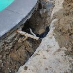 Digging out the trench around pool to backfill