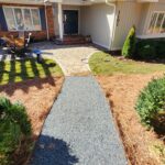 Curved gravel walkway leading to a house