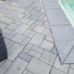 Finished outdoor pool deck with gray stone pavers