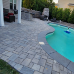 Backyard patio with solid paver patio around the pool
