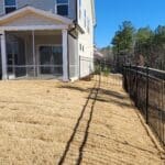 Backyard of a beige house with a screened porch, before photo