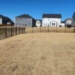 Holly Springs backyard with a black metal fence